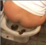 A girl stands on the edge of a toilet while shitting.